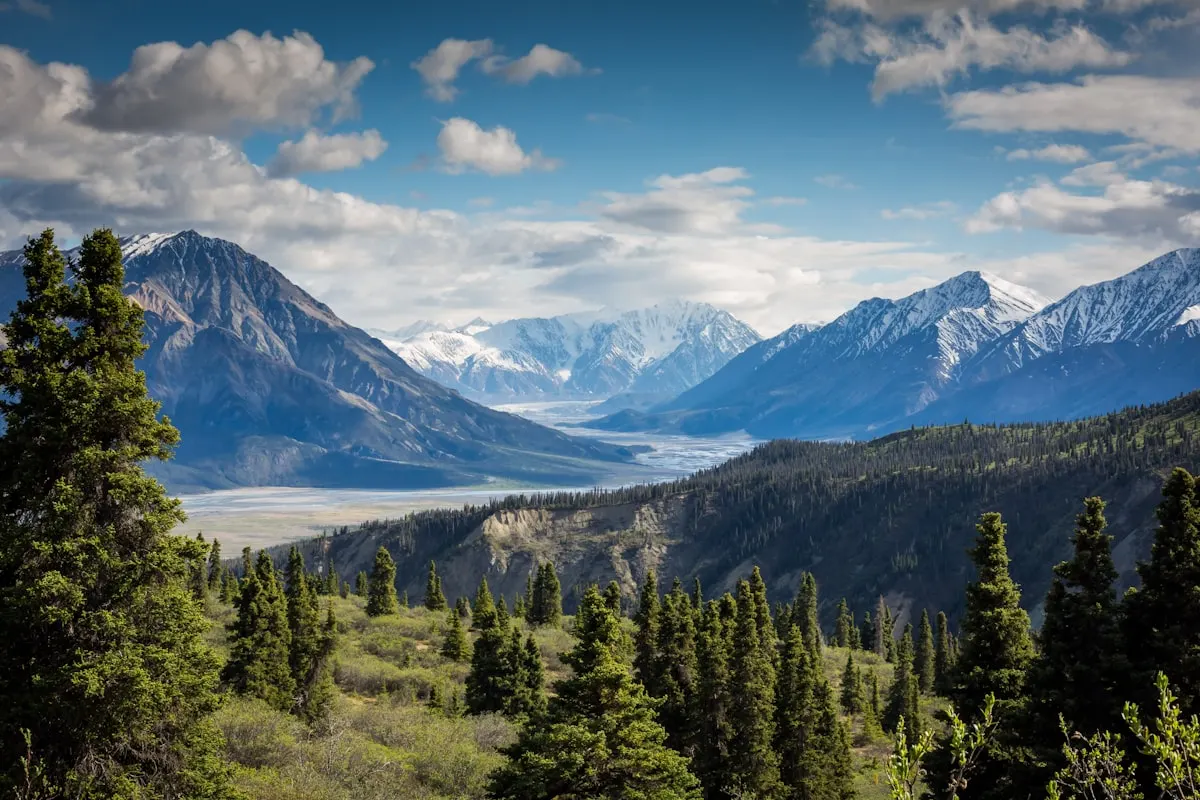 Solo travel freedom with scenic road winding towards epic mountains